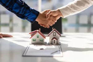 homeowners shaking hands over contract negotiation