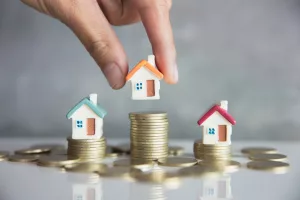 Image of homes and conins denoting property value and home equity