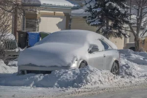 Car parked on street in snow